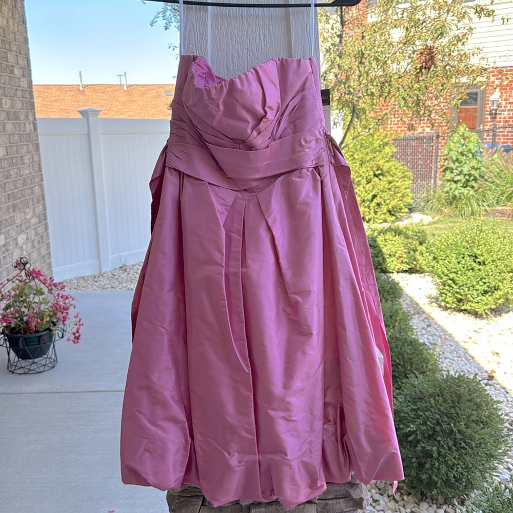 Pinish poof dress with bow in back strapless
